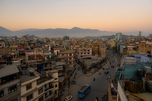 High angle view of street in Kathmandu at sunset with Himalaya mountains visible at the background