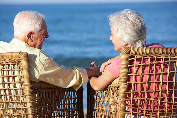 istock Senior Couple Sitting In Chairs Relaxing On Beach 175544481