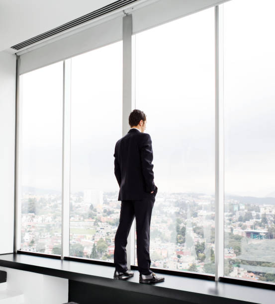 istock Young man looking out at city skyline 175544573