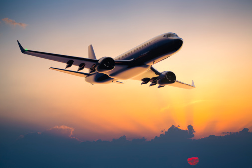 jet flight travel concept stock photo. Airplane fly above amazing blue misty mountains