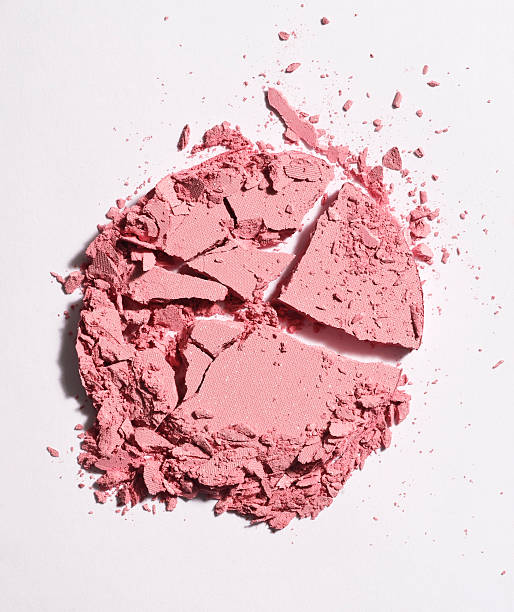 crushed pink face powder stock photo