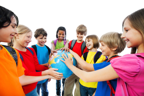 Group of children holding a Globe. They are isolated on white.