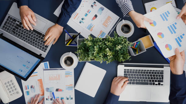 istock Top view of teamwork sharing financial company paperwork discussing management statistics 1755457967