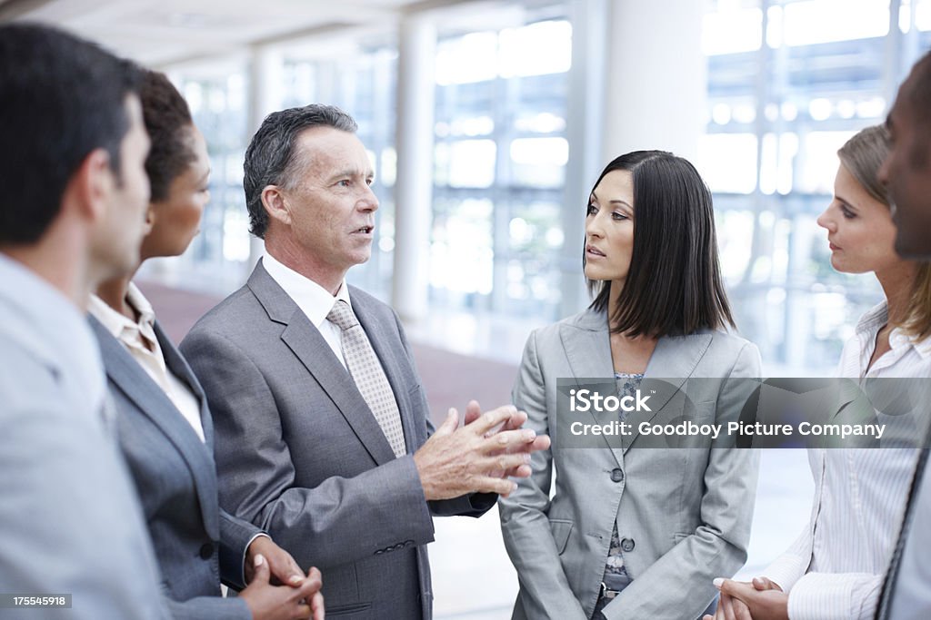 His vision is clear - Leadership Focused senior businessman deep in discussion with his team Active Seniors Stock Photo