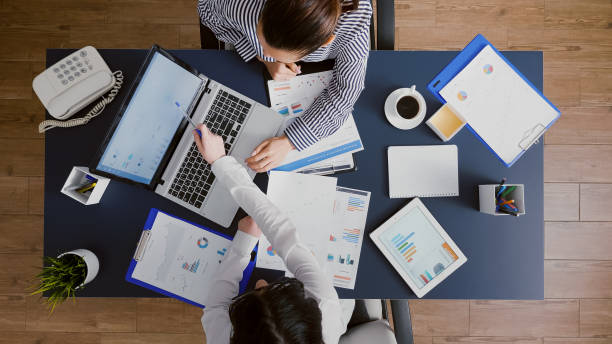 istock Top view of business women teamwork analyzing marketing graphs documents 1755461127
