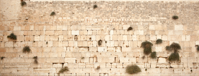 HaKotel HaMa'aravi- the western wall in Jerusalem, Israel in the afternoon,  located in the Old City of Jerusalem at the foot of the western side of the Temple Mount.  It is the most sacred site recognized by the Jewish faith outside of the Temple Mount itself. Wall background.
