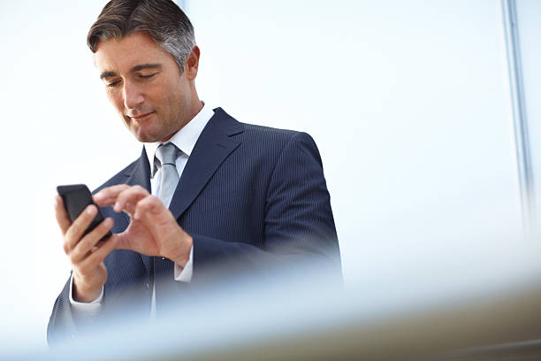 istock Handsome businessman typing on his mobile device 175546714