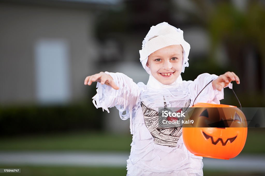 Boy in halloween costume Boy (8 years) wearing Halloween costume. Mummified Stock Photo