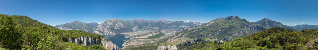 A panoramic view of the northern tip of Lake Garda, Italy. Lake Garda is the largest lake in Italy. It is located in Northern Italy. The northern part of the lake is narrower, surrounded by mountains, the majority of which belong to the Gruppo del Baldo. The particularly mild climate favored the growth of some mediterenean plants, including the olive tree.