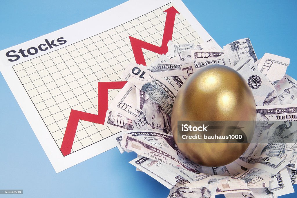 Stocks Nest Egg A nest has been created from money and a golden egg sits in the middle of the nest. The nest is resting on a Stocks Graph that is showing an upswing in the chart.SEE MY PORTFOLIO FOR OTHER VIEWS AND CONCEPTS USING THE MONEY NEST AND GOLDEN EGG. Gold Colored Stock Photo