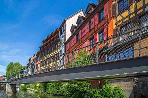 Strasbourg, Alsace: Passerelle des Anciennes-Glacières with row of buildings in typical Alsatian medieval architecture along the Canal du Faux-Rempart.