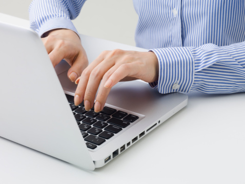 Business woman types a keyboard 