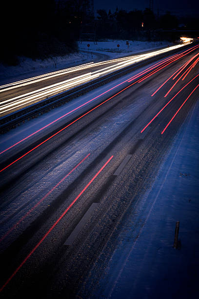 istock Snow-covered highway at night - long exposure, blurred motion 175547053
