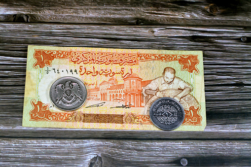 Syrian money background of old coins and banknotes of Livres Liras of different eras, old vintage retro Syria money coin and bills, exchange rate, economy status of Syria, vintage retro ancient money, selective focus