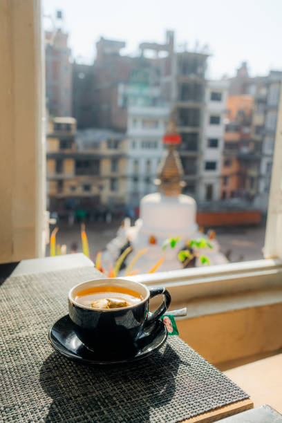 istock Cup of tea with the view on white stupa in Kathmandu 1755473214