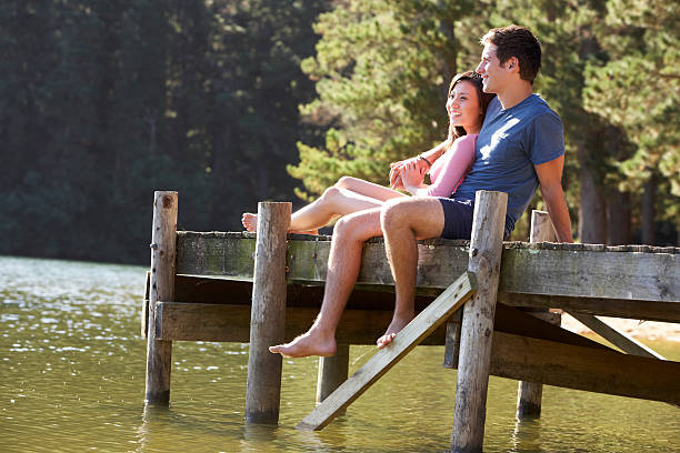 istock Young Romantic Couple Sitting On Wooden Jetty 175547326
