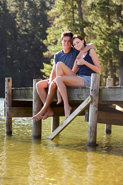 istock Young Romantic Couple Sitting On Wooden Jetty 175547329