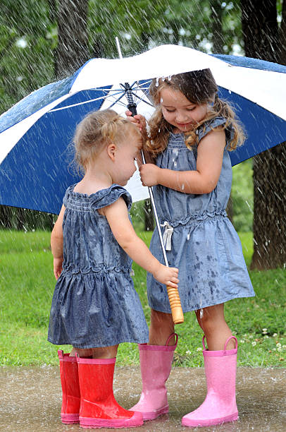 istock Two Young Sisters Playing Outside in the Rain 175547358