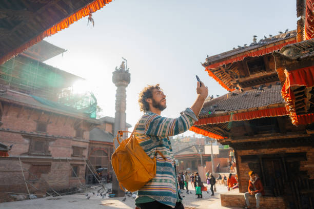istock Man taking photos on smartphone while exploring   Bhaktapur Durbar square in Kathmandu 1755475252
