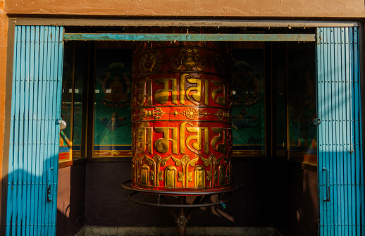 Sun lit praying wheel in Buddhist temple in Kathmandu, Nepal