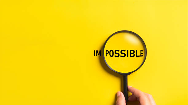 istock Hand holding magnifying glass with possible and impossible words on the yellow background. Optimistic and Business metaphor concept. 1755479570