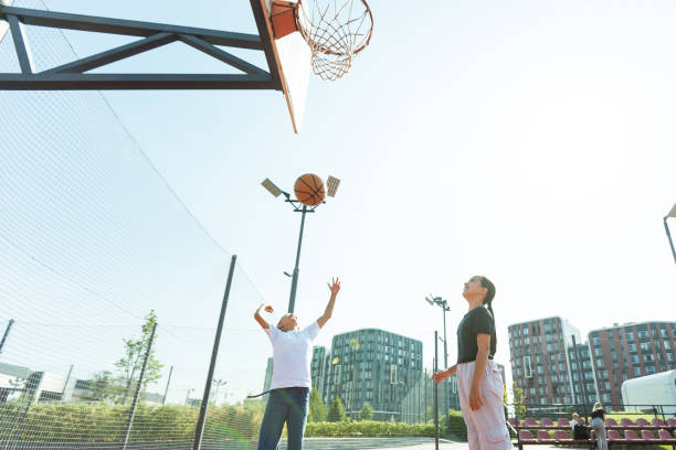girls playing basketball on the basketball court girls playing basketball on the basketball court. High quality photo backside for a girl on the beach stock pictures, royalty-free photos & images