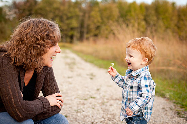 istock Mother Smiling at Little Son Holding Wildflower 175548248