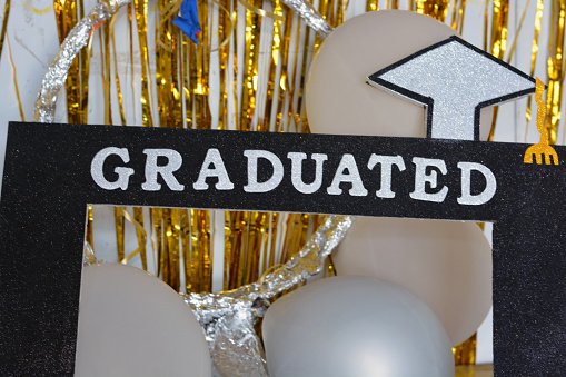 A frame with the word graduated for a graduation party, University college graduation, educational, graduates concept, class, school, learning, graduated concept, happiness, congratulations, selective focus