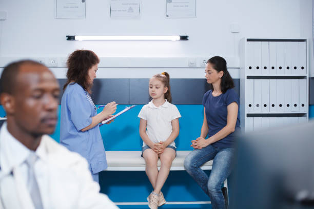 istock Nurse assisting mother and daughter 1755493332