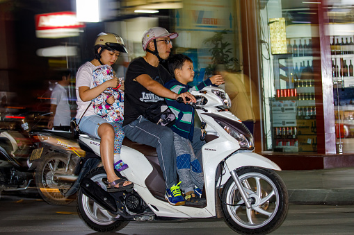 Hanoi, Bac Bo, Vietnam - November 25, 2019: People on Scooters in the city of Hanoi in Vietnam
