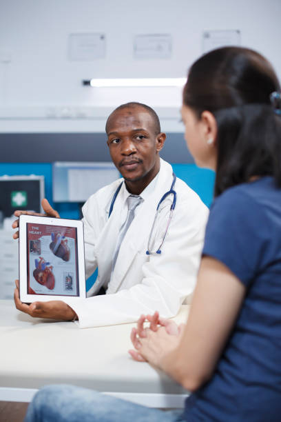 istock Physician holds tablet with heart image 1755508971