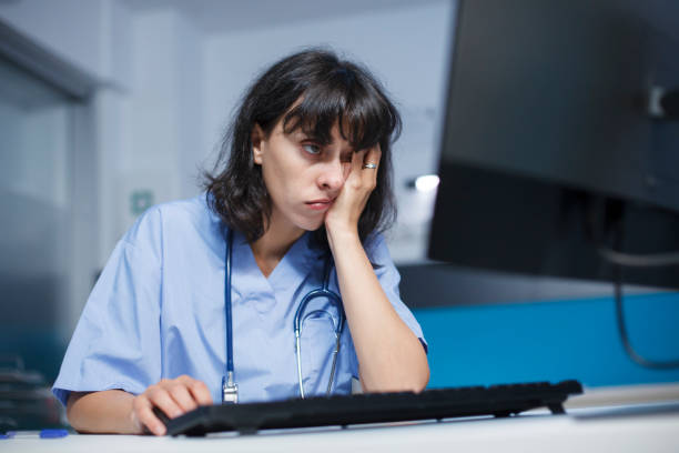 istock Tired woman using desktop pc in clinic 1755517545