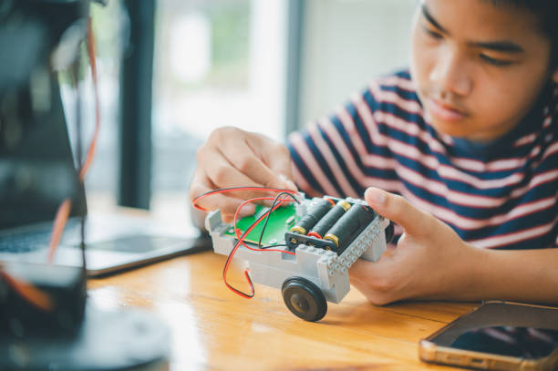 istock Asian boy learning and studying the work of technology robots.homeschool and science for tech project. playing childhood kids hobby leisure lifestyle people toys robotics technology. 1755551607