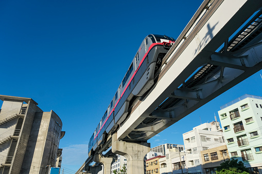 Okinawa Urban Monorail running between buildings