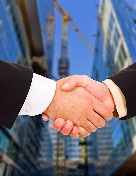 Business men hand shake in the city stock photo