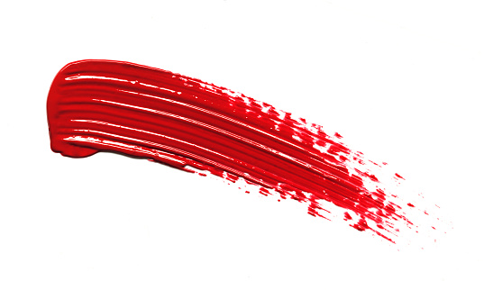 Red glossy lipstick texture stroke isolated on white background. Cosmetic product smear smudge swatch