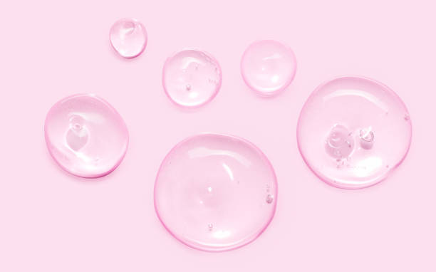 istock Serum oil sample swatch round shape texture isolated on pastel pink background. cosmetic Hyaluronic acid retinol collagen science lab product 1755558702