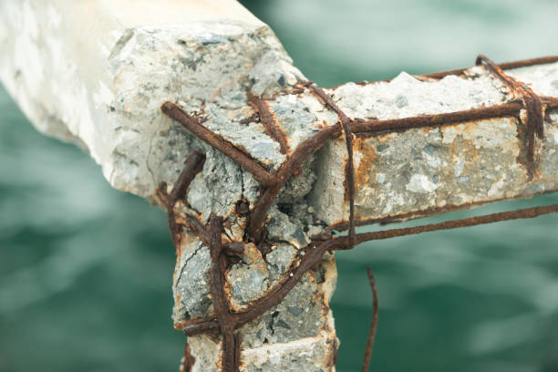 Pier bridge, rusty concrete railing, iron bar, rustic cement, sea background.