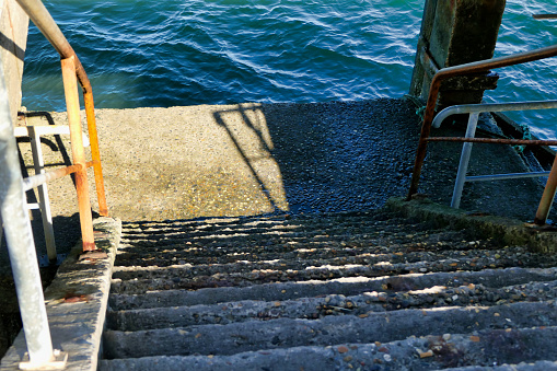Concrete stairs leading down to the sea, situated by Thiers Pier in the popular holiday resort of Arcachon in the Gironde, France