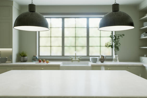 istock Kitchen interior with an island with a white stone countertop - for placing and advertising products against the blurred background of the kitchen by the window. 3D rendering 1755570302