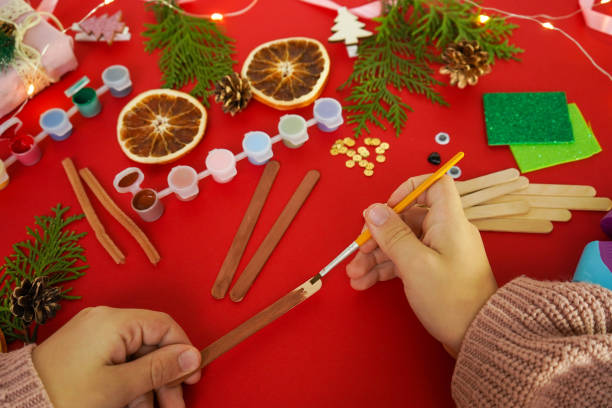 istock Step by step instruction how to make christmas deer from ice cream sticks. Step 2 painting sticks brown. Children's New year handmade craft 1755570827