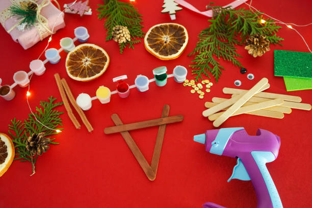 istock Step by step instruction how to make christmas deer from ice cream sticks. Step 3 glue sticks together. Children's New year handmade craft 1755570858