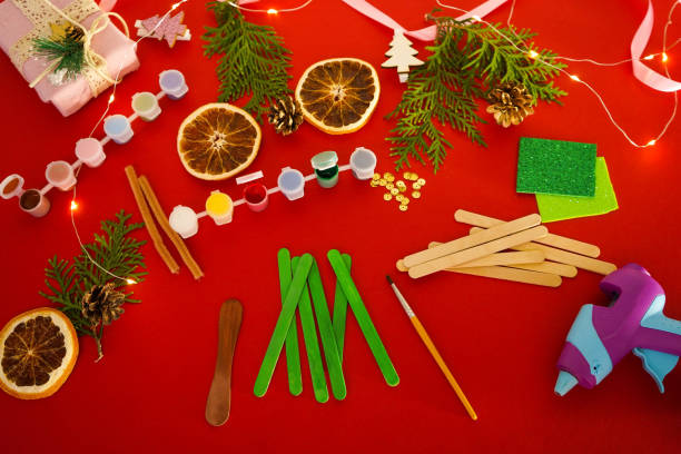 istock Step by step instruction how to make christmas tree from ice cream sticks. Step 2 painting sticks green and brown. Children's New year handmade craft 1755570860