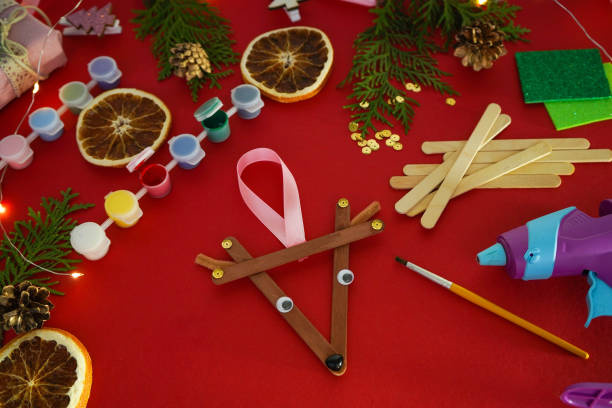 istock Step by step instruction how to make christmas deer from ice cream sticks. New year handmade craft deer 1755571386