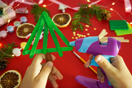 Step by step instruction how to make christmas tree from ice cream sticks. Step 3 glue sticks together. Children's New year handmade craft
