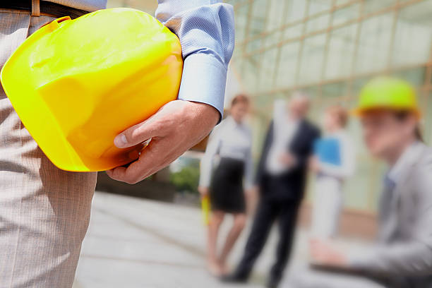 Businessman with construction yellow helmet stock photo