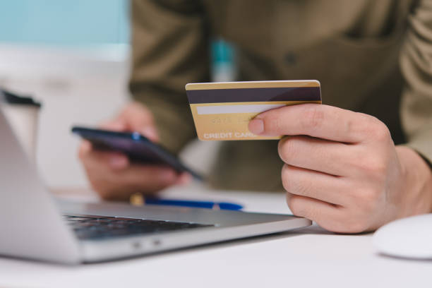 istock online payment internet hand holding card credit transaction with computer laptop 1755592471