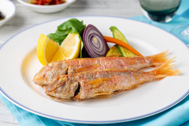 istock Grilled mullet fish with arugula and mini vegetables on a white porcelain plate 1755593070