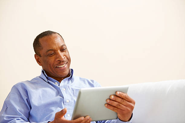 istock Happy middle aged man watching something on his digital tablet 175559558