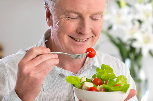 istock Happy mature man eating salad 175559917